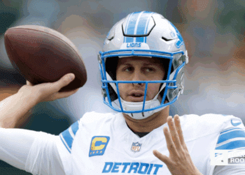 Jared Goff of the Detroit Lions drops back to pass against the Baltimore Ravens under the Monday Night Football lights.