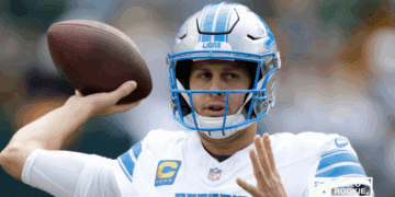 Jared Goff of the Detroit Lions drops back to pass against the Baltimore Ravens under the Monday Night Football lights.