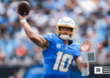 Justin Herbert of the Los Angeles Chargers drops back to pass against the Las Vegas Raiders in a key AFC West matchup.