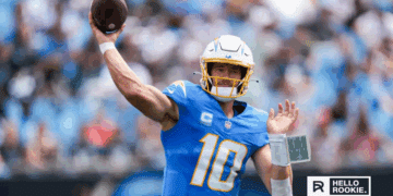 Justin Herbert of the Los Angeles Chargers drops back to pass against the Las Vegas Raiders in a key AFC West matchup.