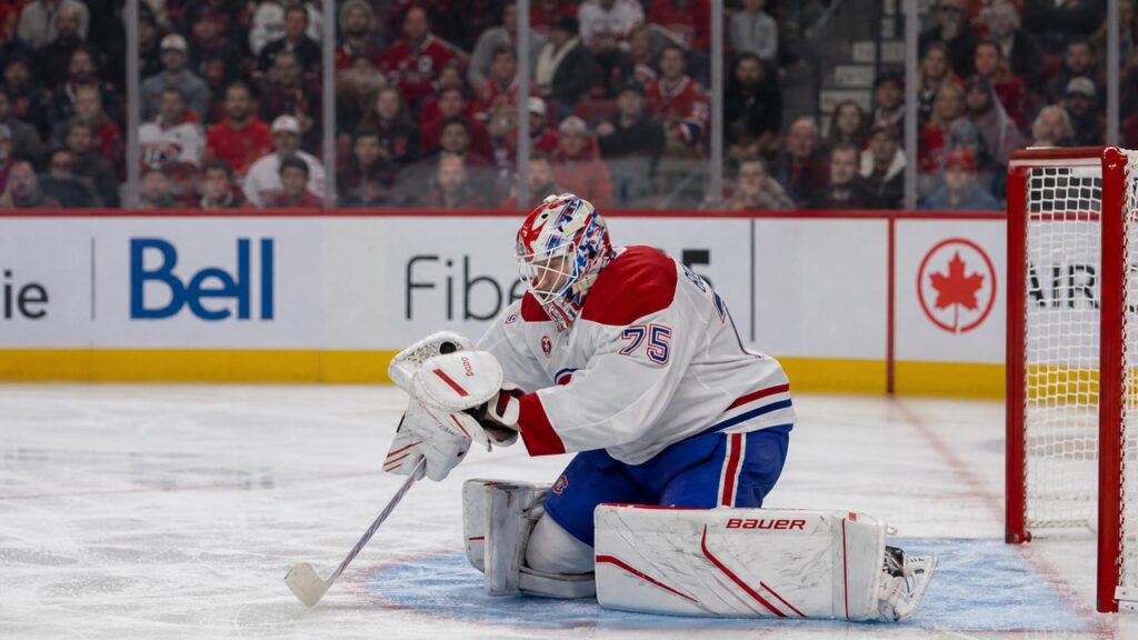 Jakub Dobes making a glove save for the Montreal Canadiens