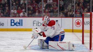 Jakub Dobes making a glove save for the Montreal Canadiens