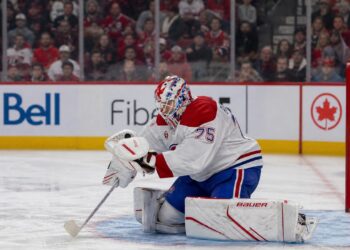 Jakub Dobes making a glove save for the Montreal Canadiens