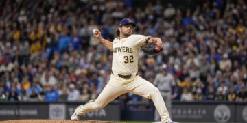 Milwaukee Brewers pitcher in wind-up delivery on the mound