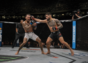 Ilia Topuria landing a right cross inside the UFC octagon