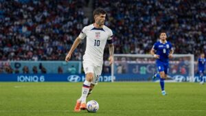 Christian Pulisic dribbling in a World Cup soccer match