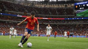 Spanish soccer player in red national team jersey dribbling at a World Cup match in Atlanta