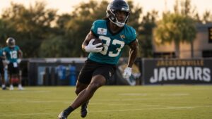 Bhayshul Tuten running with the ball for the Jacksonville Jaguars