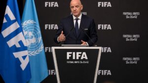 Gianni Infantino speaking at a FIFA press conference podium