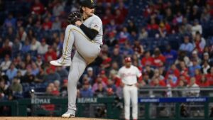 A pitcher in full wind-up on the mound at Citizens Bank Park during a night game