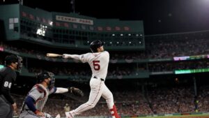 Caleb Durbin mid-swing home run follow-through for the Boston Red Sox