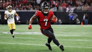 Bijan Robinson running with the ball for the Atlanta Falcons after signing his record contract extension