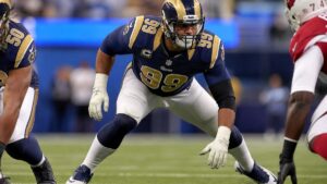 Aaron Donald in a Los Angeles Rams uniform in a defensive lineman pass rush stance