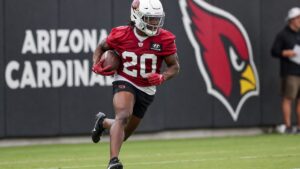 Jeremiyah Love running with the ball for the Arizona Cardinals