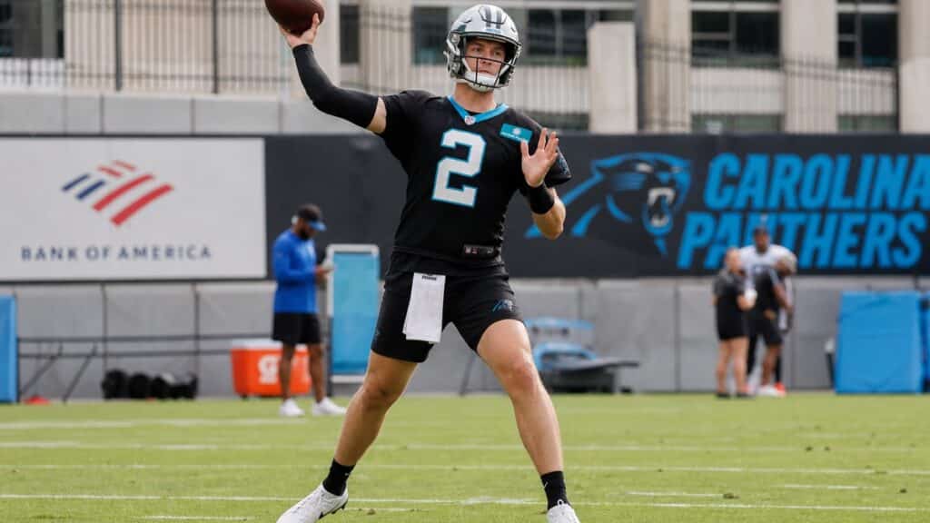 Kyle Trask throwing a pass in a Carolina Panthers uniform during practice