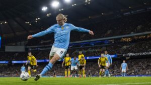 Erling Haaland striking a shot on goal for Manchester City