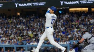 Shohei Ohtani mid-swing at bat for the Los Angeles Dodgers