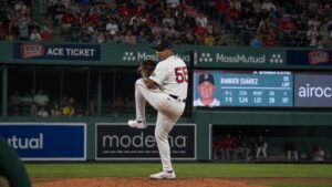 Ranger Suarez pitching in mid-windup for the Boston Red Sox