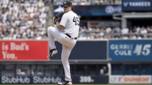 Gerrit Cole pitching in mid-windup for the New York Yankees