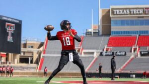 College football quarterback in Texas Tech Red Raiders uniform throwing a pass