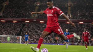 Alexander Isak striking a shot for Liverpool FC at Anfield