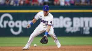 Ezequiel Duran fielding a ground ball at shortstop for the Texas Rangers at Globe Life Field