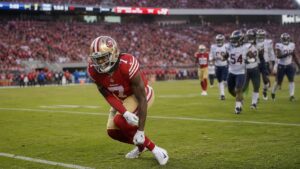 De'Zhaun Stribling in San Francisco 49ers uniform reacting to an ankle injury during a game