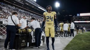 Georgia Tech Yellow Jackets defensive back on the sideline during a night game against Tennessee