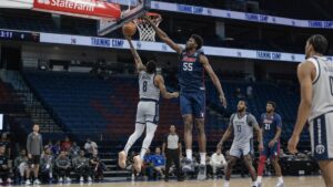 Tacko Fall blocking a shot near the rim in a Philadelphia 76ers jersey during training camp