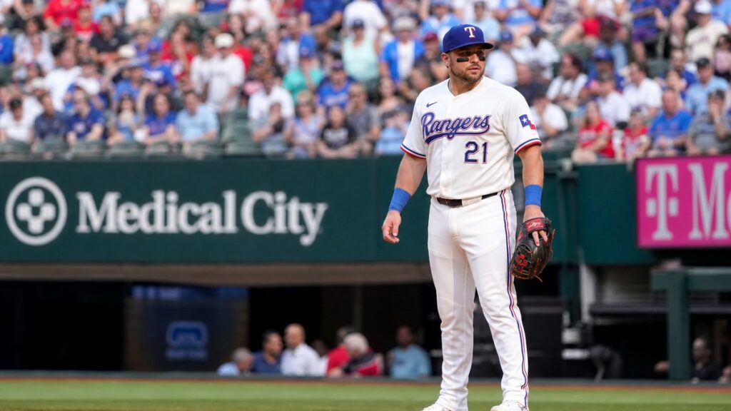 Jake Burger fielding at first base for the Texas Rangers at Globe Life Field