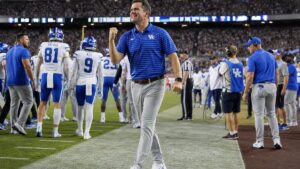 Kentucky head coach Will Stein celebrates on the sideline after the Wildcats upset Texas A&M at Kyle Field