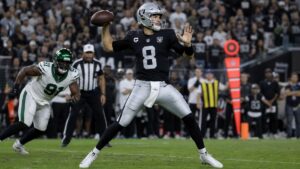 Kirk Cousins throwing a pass for the Las Vegas Raiders