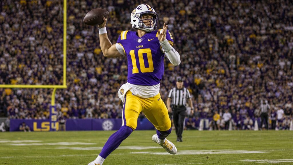 LSU quarterback in purple and gold jersey number 10 scrambling during a night game against Clemson