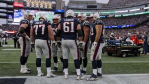 Patriots offensive line and medical staff on the sideline at Gillette Stadium after Mike Onwenu ankle injury