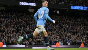 Manchester City midfielder in match action during the Manchester derby, wearing the sky blue home kit