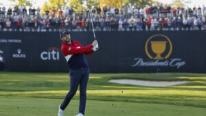 Scottie Scheffler hitting an approach shot at the Presidents Cup at Medinah Country Club