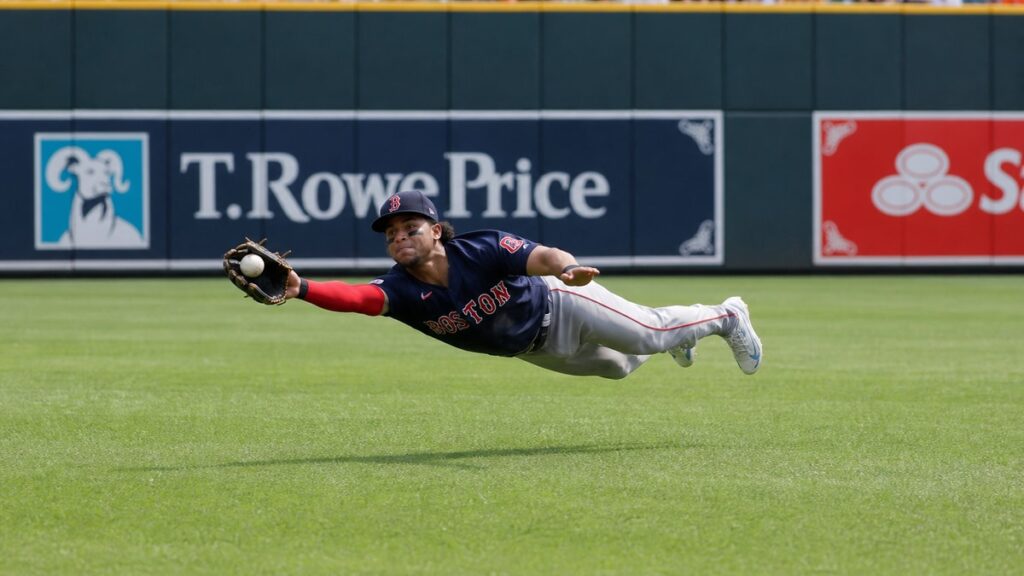 Ceddanne Rafaela of the Boston Red Sox making a diving catch in center field against the Baltimore Orioles