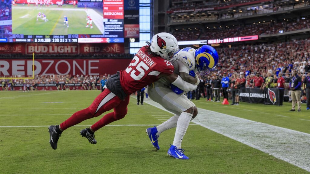 Will Johnson, Arizona Cardinals cornerback, making a tackle during an NFL game