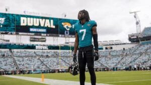 Brian Thomas Jr. of the Jacksonville Jaguars on the sideline holding his helmet