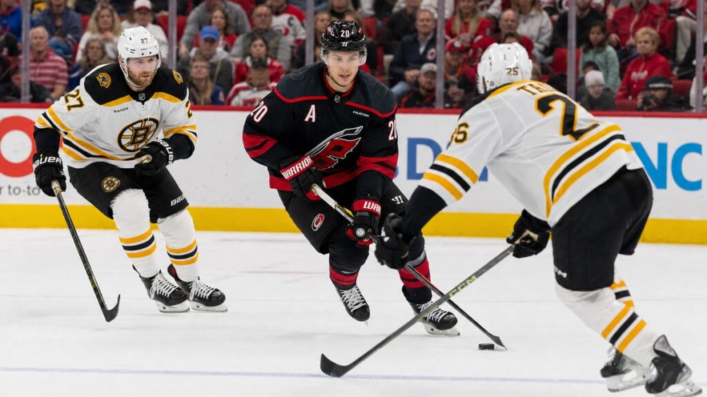 Sebastian Aho of the Carolina Hurricanes carrying the puck against the Boston Bruins