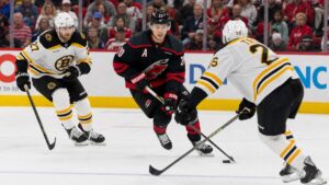 Sebastian Aho of the Carolina Hurricanes carrying the puck against the Boston Bruins