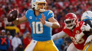Justin Herbert of the Los Angeles Chargers dropping back to pass at Arrowhead Stadium