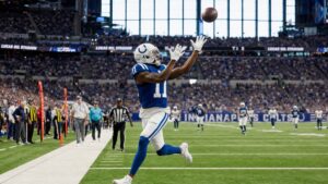 Indianapolis Colts wide receiver reaching for a deep pass at Lucas Oil Stadium