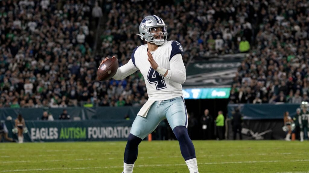 Dak Prescott of the Dallas Cowboys dropping back to pass in a night game at Lincoln Financial Field