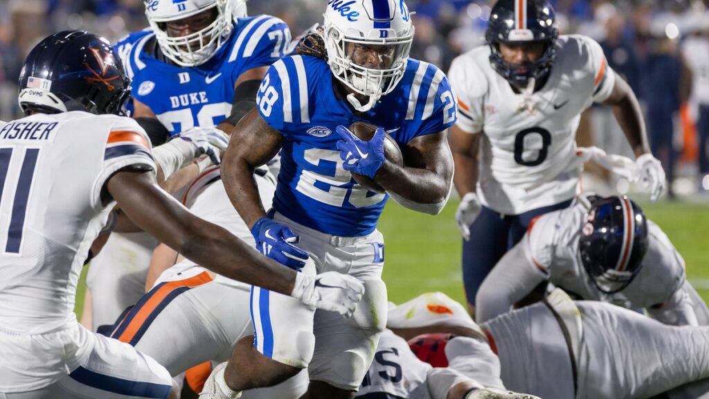 Duke Blue Devils running back Nate Sheppard carrying the football during a night game at Virginia's Scott Stadium