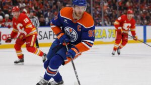Connor McDavid of the Edmonton Oilers skating with the puck against the Calgary Flames