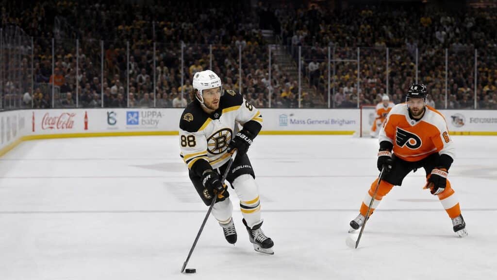 David Pastrnak skating with the puck for the Boston Bruins against the Philadelphia Flyers