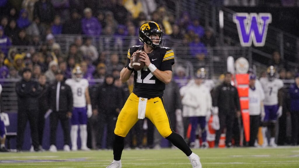 Iowa quarterback dropping back to pass at Husky Stadium against Washington