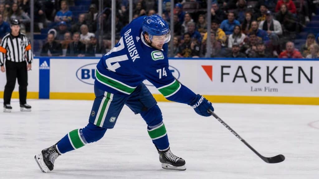 Jake DeBrusk taking a shot on goal for the Vancouver Canucks