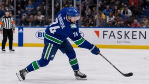 Jake DeBrusk taking a shot on goal for the Vancouver Canucks